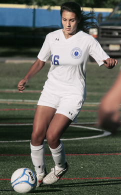 SURVIVAL MENTALITY: Princeton Day School girls’ soccer player Lilly Razzaghi clears the ball in a game earlier this season. Senior defender Razzaghi and her teammates survived a major scare in the opening round of the Mercer County Tournament last Saturday as top-seeded PDS edged No. 16 Hamilton 3-2 in overtime. The Panthers came back on Monday and topped ninth-seeded Robbinsville 3-0 in the MCT quarterfinals to improve to 14-1-1 and set up a semifinals clash with fourth-seeded Princeton High on October 30 with the winner advancing to the title game on November 2. PDS is also competing in the state Prep B tournament where it is seeded first and hosting fifth-seeded Rutgers Prep in the semifinals on October 31 with the victor earning a spot in the championship game on November 3.(Photo by Frank Wojciechowski)