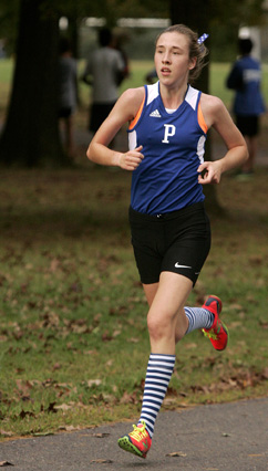 ON PACE: Princeton High girls’ cross country runner Mary ­Sutton heads to the finish line in a recent race. Junior standout Sutton helped PHS take fourth last Saturday in the Fall Classic Varsity A race at Thompson Park in Lincroft. Sutton placed 11th overall, covering the 3.1 mile course in 20:09. Sophomore Lou Miahle led the way for the Little Tigers, taking 10th in 20:06. In upcoming action, PHS competes in the county meet on October 25 before starting state competition with the sectionals in early November.(Photo by Frank Wojciechowski)