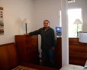 FINE FURNITURE: “Customers really like the simple clean lines of our furniture — the elegant and sleek look. We focus on both Scandinavian and contemporary furniture.” Roberto Hajek, owner of Contemporary Designs in Hopewell, is shown by a handsome solid teak dresser and queen size teak bed.