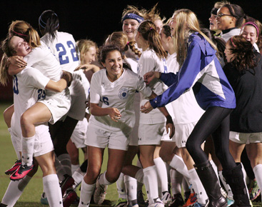 GLORY DAY: Players on the Princeton Day School girls’ soccer team celebrate in the wake of beating Hopewell Valley 2-0 last Saturday in the Mercer County Tournament championship game. It was the first-ever MCT crown for the program. A day later, PDS fell short of a title double as it lost 2-0 to Morristown-Beard in the state Prep B championship game. The Panthers finished the fall with a 17-2-1 record.(Photo by Frank Wojciechowski)