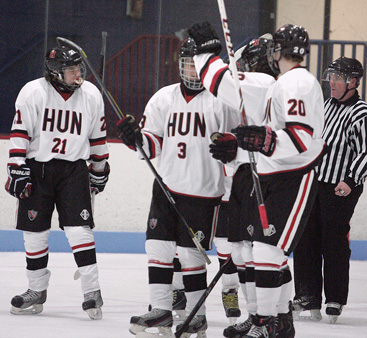 FREQUENT OCCURRENCE: Hun School boys’ hockey player Brad Stern (No. 3) celebrates with Jon Bendorf (No. 21) and Bobby Wurster (No. 20) after a goal in recent action. Senior defenseman Stern and the Raiders have been torrid offensively in the early going this season, averaging 9.5 goals a game as they have produced a 3-1 start.(Photo by Frank Wojciechowski)