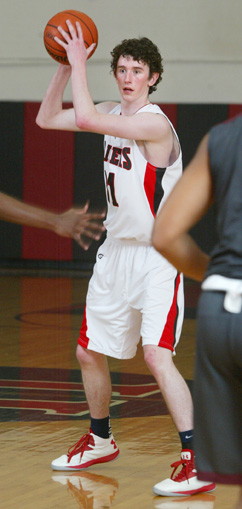 BIG MAC: Hun School boys’ basketball player Josh McGilvray looks to to pass the ball in a game last season. The 6’8 senior center figures to be a key player for Hun as it looks to build on last winter’s success which saw it win the Mid-Atlantic Prep League (MAPL) tournament and post a 20-6 record. The Raiders tip off their 2013-14 campaign by playing at The Phelps School (Pa.) on December 5.(Photo by Frank Wojciechowski)