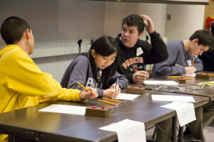 GROUP THINKING: Members of the Princeton High School team competing in the Science Bowl seem cool, calm, and collected as they figure out the answer to a bonus question in the round against the Bergen County High School team on Saturday. The PHS team reached the 10th round of the U.S. Department of Energy’s New Jersey Regional High School Science Bowl on Saturday at the Princeton Plasma Laboratory before their defeat. From left: Alexander Jin, Stephanie Ren, Rye Anderson, and Enric Boix.(Photo by Elle Starkman/PPPL Office of Communications)