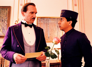 LEARNING FROM THE MASTER: The so called “Lobby Boy” Zero Moustafa (Tony Revolori, right) is learning the tricks of the hotel trade from Monsieur Gustave (Ralph Fiennes), the concierge of the Grand Hotel Budapest.