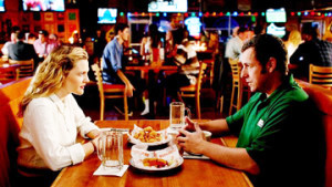 THIS COULD BE THE START OF SOMETHING BIG: Jim (Adam Sandler, right) and Lauren (Drew Barrymore) meet online and arrange to meet for dinner at a Hooter’s restaurant. That choice of venue appears to be fatal to the continued development of their relationship because Jim pays more attention to the waitresses and the big game on TV than he does to Lauren. Nonetheless, the pair and their children are thrown together after a series of improbable coincidences and love is given another chance to bloom between the pair. 