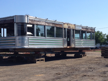 SAVED FROM THE WRECKING BALL: The diner on Route One that was recently named to Preservation New Jersey’s “10 Most Endangered” list is lifted on pallets in preparation for its move to a mixed-use redevelopment site in Hamilton.(Photo by Michael Competielle)