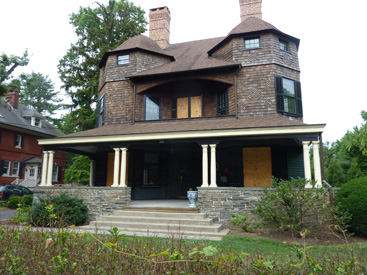 WHERE THERE’S FIRE, THERE’S SMOKE: The boarded up windows of this Shingle Style home on Bayard Lane will soon be replaced by glass as the house is refurbished to its former splendor during the next few months. A fire in the basement of one of the home’s two condominiums last March caused major smoke damage, but all is now on track to have the family move back in my the November holidays.(Photo by Linda Arntzenius)