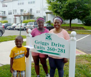 PRINCETON PERSPECTIVES: Elizabeth Bonnah and her children Aba, 12, and Koby, 5, are all smiles as they pose for this photograph outside the condominium they rent at Griggs Farm. Not pictured is Tony Smith, the children’s father, who was working at his Princeton University job. Originally from Ghana, the couple spent years apart before being reunited in Princeton, which is now their home. They hope one day to own their own home, purchased through Princeton’s Affordable Housing Program. This story is the second in a series focused on Princeton residents, some newcomers, others with deep connections to the town. The U.S. Census reports the town as having about 30,000 residents and the series hopes to shine a little light on some of them.  (Photo by L. Arntzenius)