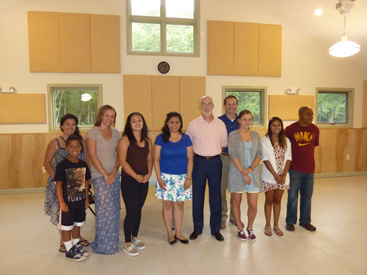 IT TAKES A VILLAGE: Proud parents and residents of Princeton Community Village celebrated the scholars in their midst at a celebration for students receiving awards from the New Jersey and National Affordable Housing Management Associations (JAHMA and NAHMA). The award winners with their family members are: from left: Stephanie Nazario, parent, and Isaiah Nazario, brother of award winner Christian James Nazario; guest speaker and program alumna Kyleigh Pope; Vanessa Guzman, Phoebe Hanna; JAHMA and NAHMA Scholarship Administrator Bruce Johnson; Frank Chmiel with his daughter Jackie Chmiel; Cindy Guzman; and Emmanuel Ebong, representing his daughter Mary Ebong who was working and could not attend. Also not pictured were scholarship recipients: Jonas I. Daniecki, Hiba Fatima, Christian James Nazario, and Chelsea M. Pierre; and guest speaker Officer Shahid-Abdul Karim.(Photo by L. Arntzenius)