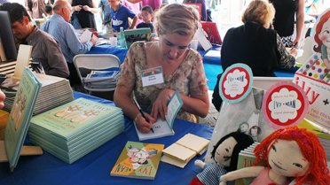 SIGNING: Illustrator Sophie Blackall signing a copy of Annie Barrows’s “Ivy + Bean” at a recent Prince-ton Public Library Children’s Book Festival. This year’s event will take place Saturday, September 20, from 11 a.m. to 4 p.m., rain or shine, on Hinds Plaza or in the library’s Community Room.