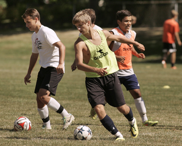 GETTING THEIR KICKS: Members of the Princeton High boys’ soccer team go through a drill during a practice last week at the Valley Road fields. PHS, which posted a 10-6-2 record last fall, starts its 2014 campaign by playing at Trenton High on September 5.(Photo by Frank Wojciechowski)