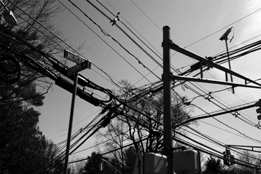 INSIGHT FOR SORE EYES: Offering a strange if grotesque beauty, the above ground power and telephone lines at the intersection of Lover’s Lane and Mercer Street in Princeton are a sight that most of us take for granted. Photographer Alan Chimacoff hopes to change that and prompt those who view his work on display at the Princeton Public Library into a discussion that would see all such wires moved underground by the year 2020. Mr. Chimacoff will discuss his view at the library Thursday evening at 7 p.m. in the Community Room.(Image courtesy of the artist)