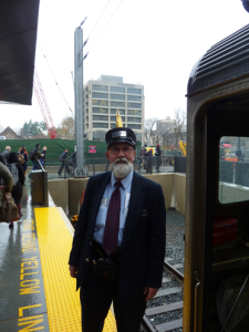 ALL ABOARD: Like many Dinky users on Monday, Conductor Bob Gibbs is all smiles as the new Princeton station opened. Commuters found a cherry electronic message board welcoming them to Princeton University and enjoyed free coffee inside the waiting room. (Photo by L. Arntzenius)