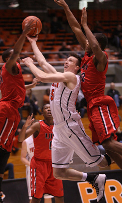 PRESSURE COOKER: Princeton University men’s basketball player Steven Cook fights through two University of Incarnate Word defenders last Saturday at Jadwin Gym. Sophomore Cook scored 14 points in 33 minutes off the bench but it wasn’t enough as Princeton lost 79-68 to the Cardinals. The Tigers, now 1-3, head to California this week where they will compete in the Wooden Legacy, an eight-team event Thursday through Sunday in Fullerton and Anaheim. Princeton starts play in the competition by facing UTEP on November 27.(Photo by Frank Wojciechowski)