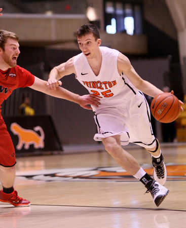 HOME COOKING: Princeton University men’s basketball player Steven Cook dribbles past a foe in recent action. Last Saturday, Sophomore guard Cook notched career highs in both points (28) and steals (7) to help Princeton rally to a 77-64 win over visiting Stony Brook. The Tigers, who improved to 3-6 with the victory, play at St. Peter’s on December 10 and at California on December 13.(Photo by Frank Wojciechowski)