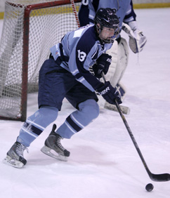 READING THE GAME: Princeton High boys’ hockey player John Reid heads up the ice in a game last winter. Senior forward Reid’s all-around game should be a big asset for PHS this winter. The Little Tigers start their 2014-15 campaign this week with games against Montgomery on December 2 and Nottingham on December 4.(Photo by Frank Wojciechowski)