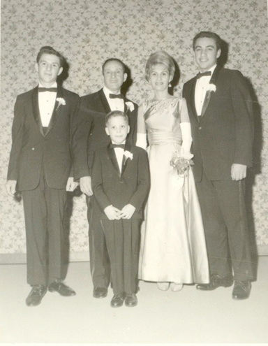 HONOR AND REMEMBRANCE: Remembering and honoring the survivors of the Holocaust is the focus of the Jewish Family & Children’s Service’s upcoming gala, the “Illumination Ball”. Shown in this photo from 1964 are two Holocaust survivors: Max Schwartz (second from left) and his wife Roza, who are the grandparents of gala chair person, Barbara Majeski. Also in the photo are Max and Roza’s sons, Robert (left), Harri, and Jeffrey (foreground) on the occasion of Robert’s bar mitzvah.