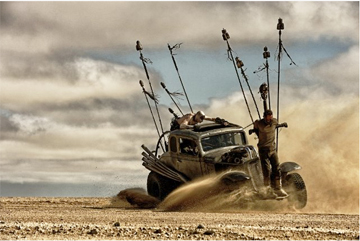 WHAT A WAY TO GET AROUND IN THE POST-APOCALYPTIC YEAR 2060: Max Rockatansky (Tom Hardy) directs the driver of his Rube Goldberg means of transportation. He will soon meet up with Imperator Furiosa (Charlize Theron, not shown) and help her in her quest to rescue a group of sex slaves from their captor Immortan Joe (Hugh Keays-Byrne, not shown).(Photo by Jasin Boland—© 2012 Warner Bros. Entertainment Inc.)