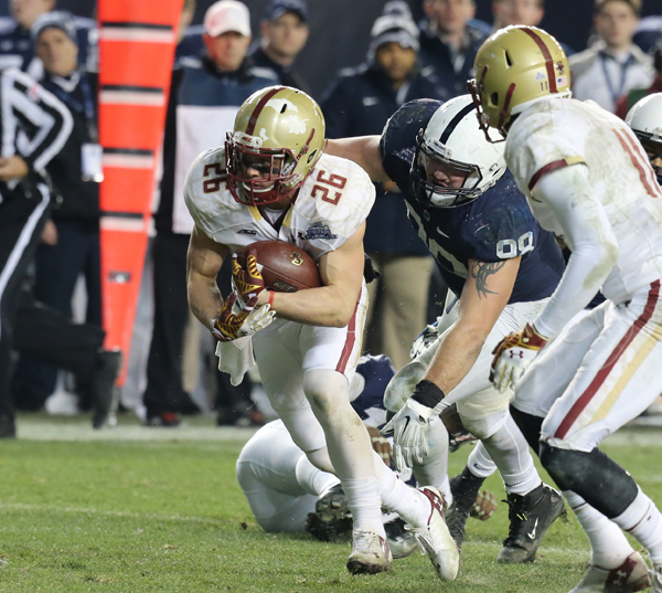 FLYING HIGH: Boston College receiver David Dudeck eludes a Penn State defender in action last December in the New Era Pinstripe Bowl at Yankee Stadium. Dudeck, a former baseball and football star at the Hun School, made a 21-yard touchdown reception in overtime in the game as Boston College lost 31-30. Dudeck is currently in preseason camp for his senior campaign with the Eagles.(Photo Courtesy of Boston College Athletic Communications)