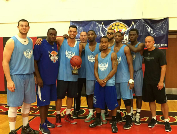 LANDMARK VICTORY: Victory Sports basketball director Bryan Caver, second from left, presents the Maselli & Warren Law Firm team with the trophy it earned for winning the Victory Sports Pro-Am League championship in the league’s inaugural season. Maselli & Warren edged CertaPro Painters 67-64 in the title game last Thursday evening at the Hun School gym.