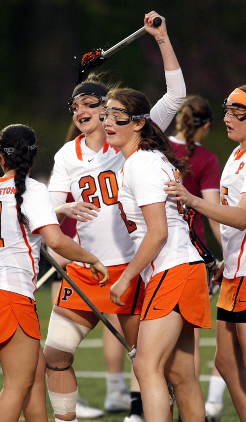 #22 (center) gets congrats after scoring P.U.'s first goal.