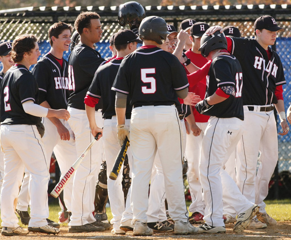 Hun player #17, 3rd from right gets congrats from players after his home run.